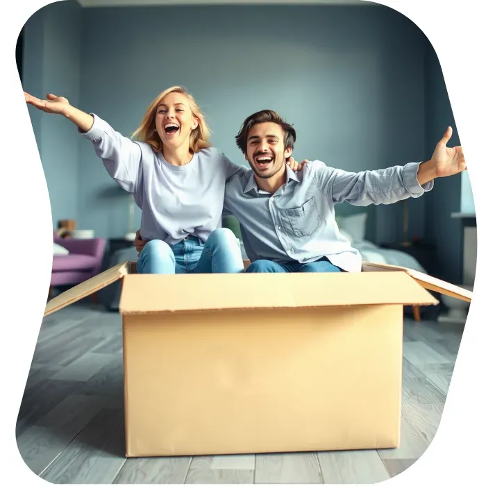 Two guys sitting on the floor of their apartment with Muval moving boxes